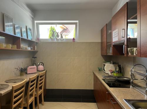 a kitchen with wooden cabinets and a counter top at Sekret Łeba Dom i Domki in Łeba