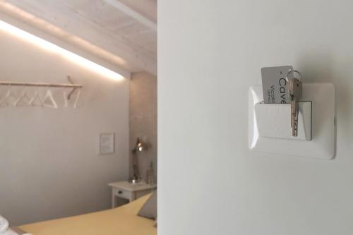 a room with a bed and a white refrigerator at Vicolo Fiore Affittacamere in Matera