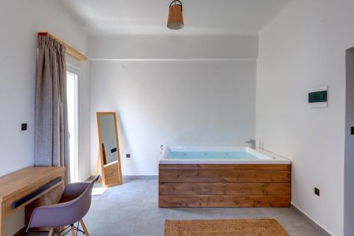 a bathroom with a wooden tub in a room at Aegean Glory Suites in Ermoupoli