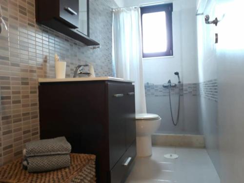 a bathroom with a shower and a toilet and a sink at Las Home Upper Floor 