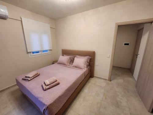 Postel nebo postele na pokoji v ubytování Giotis Apartments