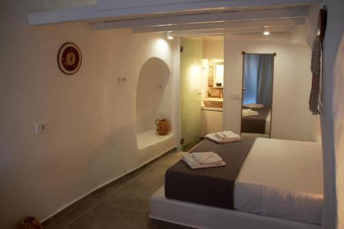 a bedroom with a bed and a bath room at il Marinero mandrakia in Mandrakia