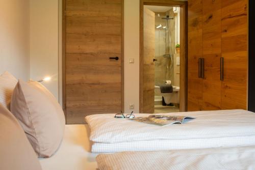 a bedroom with a bed with a book on it at Ferienwohnung Immerschön in Pfronten