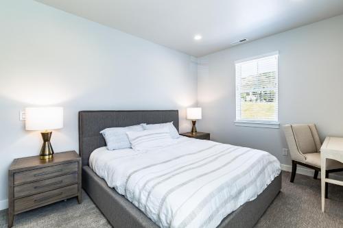 a bedroom with a bed and a desk and a chair at Modern Mountain Retreat in Keetley