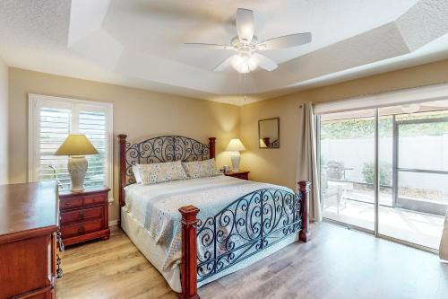 a bedroom with a bed and a ceiling fan at The Cove House in Wildwood