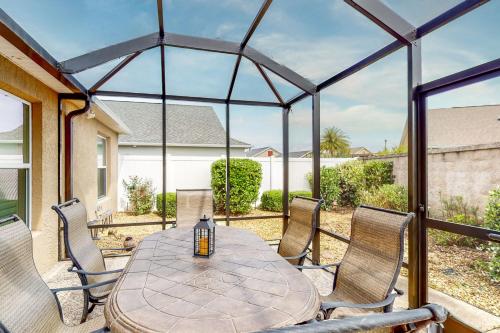 a patio with a round table and chairs at The Cove House in Wildwood