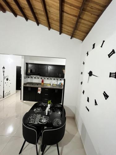 a room with a table and a clock on the wall at Apartamento de descaso por san Gil in San Gil