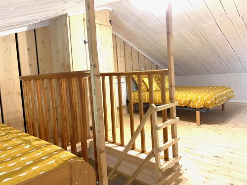 a staircase in a room with a bed and a bench at maison de vigneron in Mareugheol