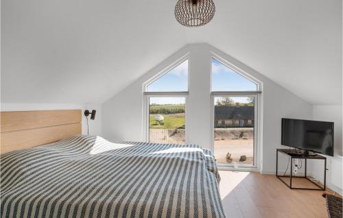 a bedroom with a bed and a large window at Havnehusene, Lejl, 54 in Slagelse