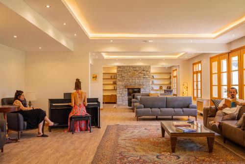 a group of people sitting in a living room with a piano at Kairos Valley Wellness & Longevity in Datca
