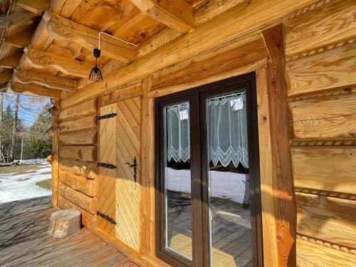 a log cabin with a window on the side of it at Domek Oźna płoscyna in Rajcza