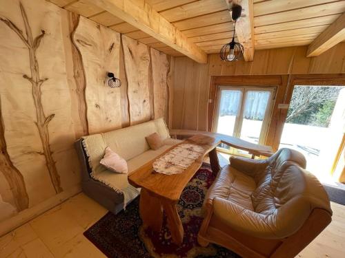 a living room with a couch and a table at Domek Oźna płoscyna in Rajcza