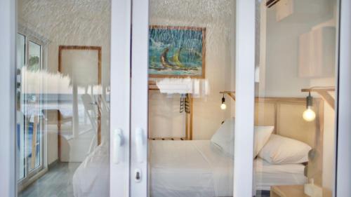 a bedroom with a bed and a view of a room at AZVLIK in Rivas