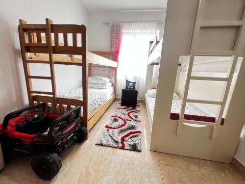 a bedroom with two bunk beds and a stroller at Chateau Sukaj in Laknas