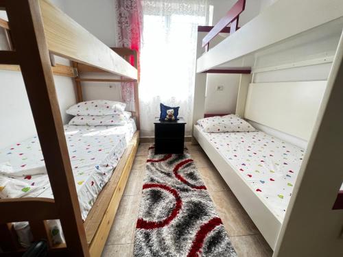 two bunk beds in a room with a window at Chateau Sukaj in Laknas