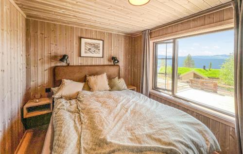 a bedroom with a bed and a large window at Gorgeous Home In Gl With Sauna in Gålå
