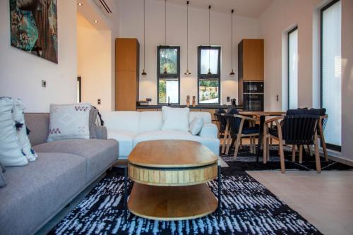 a living room with a couch and a table at Villa Dara and Todd in Sivota
