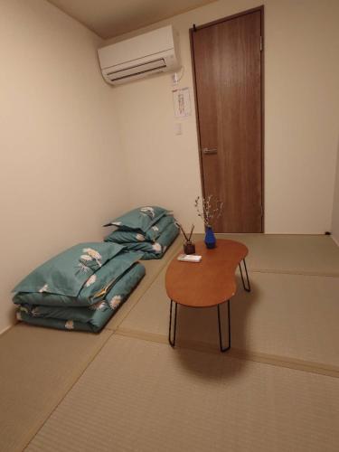 a room with a bean bag bed and a table at W&J Dream Stay in Osaka
