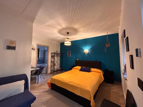 a bedroom with a bed and a blue wall at Giraluna in Demonte