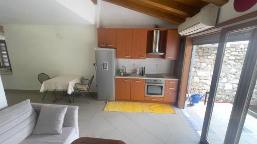 a kitchen with a couch and a table and a refrigerator at Arbe Downtown in Rab