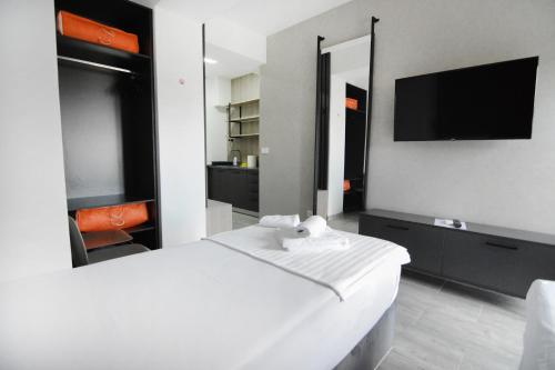 a bedroom with a white bed and a tv at Leon Luxury Apartments in Ohrid