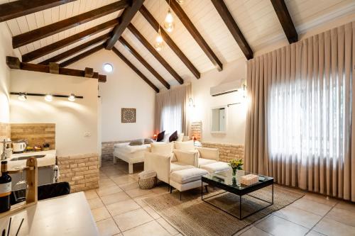 a living room with a couch and a table at Grand Vista Boutique Hotel And Spa in Yuval