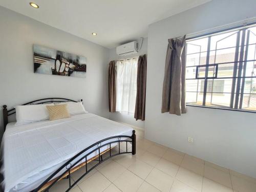 a white bedroom with a bed and a window at Blueming 2 Guesthouse Bayswater mactan THREE BEDROOM in Agus
