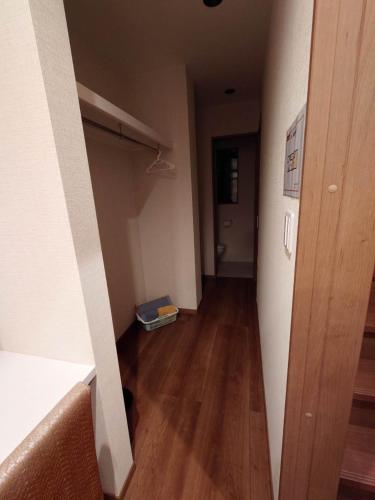 an empty room with a hallway with a hard wood floor at W&J Dream Stay in Osaka