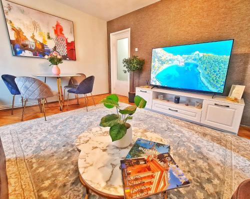 a living room with a large flat screen tv at Arc de Triomphe BlissBoutique in Bucharest