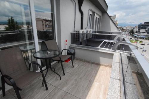 a balcony with a table and chairs on a building at Leon Luxury Apartments in Ohrid
