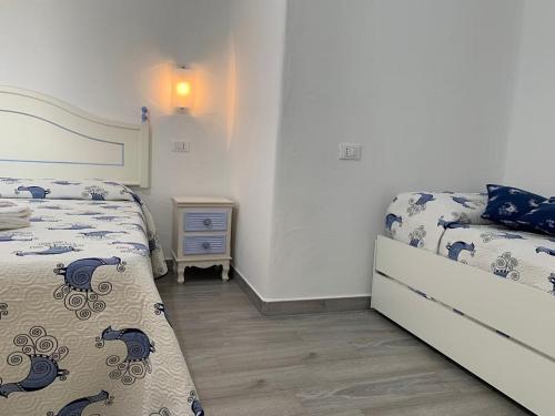 a bedroom with two beds and a night stand at Turismo Rurale Belvedere Pradonos in Dorgali