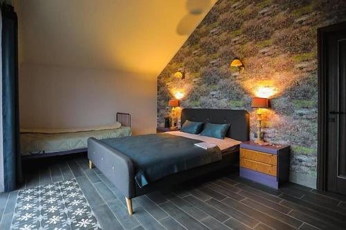 a bedroom with two beds and a wall with a mural at Cuib Complex Turistic in Căpriana