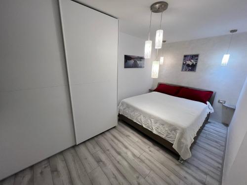 a bedroom with a bed and a large sliding door at Mali Stan Opatija in Opatija