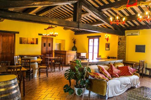 a living room with a couch and a bar at Agriturismo Dandelion in Città della Pieve