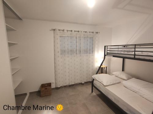 a bedroom with a bunk bed and a window at La Villa Yucca Vias Plage - 300m plage et centre in Vias