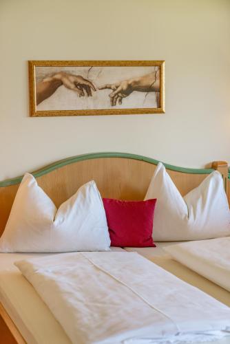 a bed with a red pillow on top of it at Apparthaus Taxegger in Haus im Ennstal