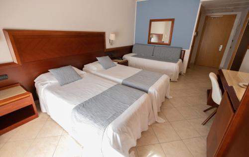 Letto o letti in una camera di Hotel Le Palme