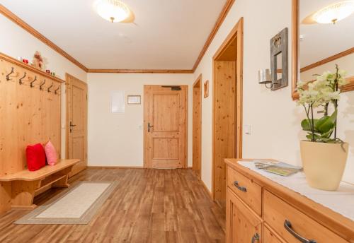 a large kitchen with wooden floors and a table at Apparthaus Taxegger in Haus im Ennstal