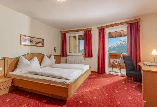 A bed or beds in a room at Apparthaus Taxegger