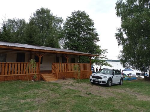 a small car parked in front of a house at Holender Przy Plaży in Wilimy