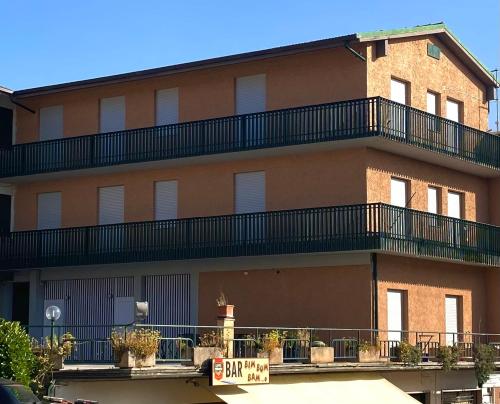 a building with a balcony on the side of it at Umbria Green Central Rooms in Castiglione del Lago