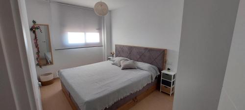 a small bedroom with a bed and a window at Apartamento Saldonar in Vinarós