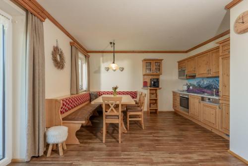 a kitchen and dining room with a table and chairs at Apparthaus Taxegger in Haus im Ennstal