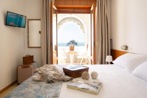 a bedroom with a bed with a view of the ocean at Villa Marin in Grado
