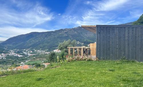 a house on the side of a grassy hill at Casa Raposa Lodges - Terrace Mountain View in Manteigas