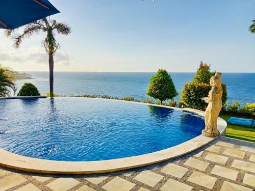 a swimming pool with the ocean in the background at Shankara Parada Villas in Amed
