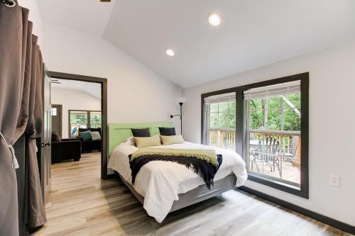 a bedroom with a bed and a large window at Creekside Cottage in Hot Springs