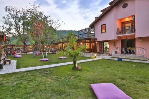 a house with purple pillows in the yard at Ağva Mints Hotel Adult Only in Ağva