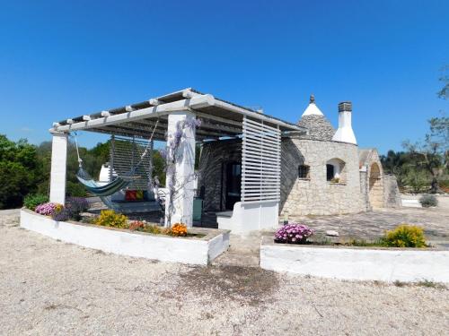 a pavilion with a fountain in front of a building at Trullo Ada in Ceglie Messapica