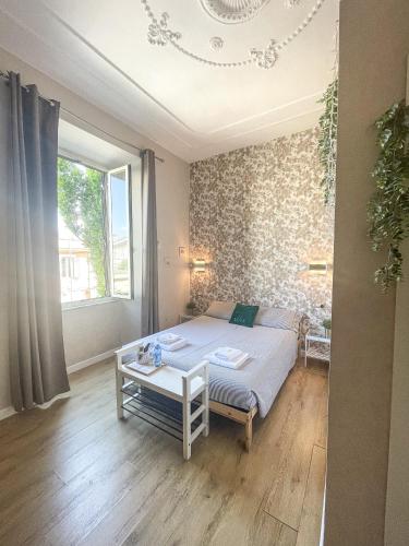 a bedroom with a bed and a table in it at Casa Lina in Civitavecchia